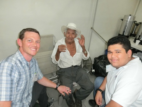 Clinic team member with community members, representing compassionate, community-centered care beyond the clinic walls