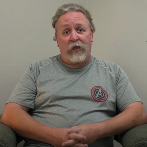 Older male patient sharing his experience during a testimonial.